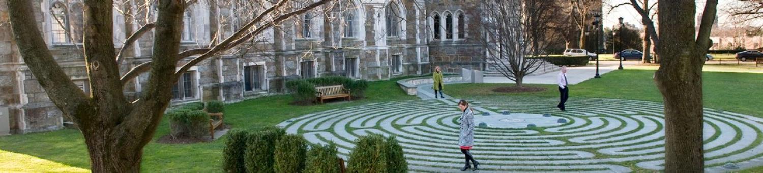 people walking the labyrinth walking path on campus